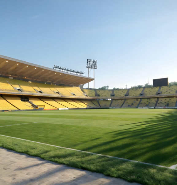 Empty soccer stadium on a sunny day with bright green grass and yellow seats